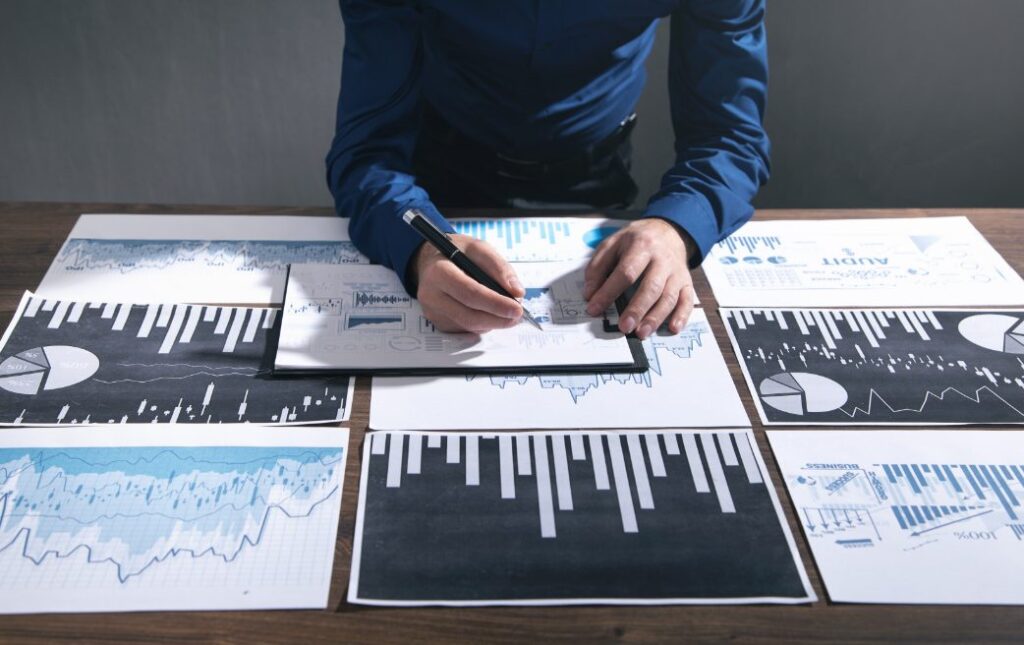 financial analytics dashboard with calculator, charts, and money management icons on laptop screen